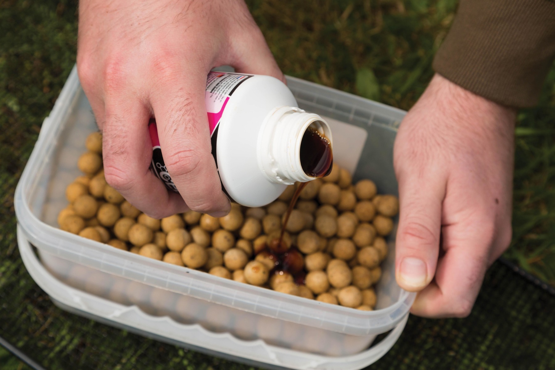 2.Once the boilies have air-dried over a couple of days, put them into a bucket and add some Activator.